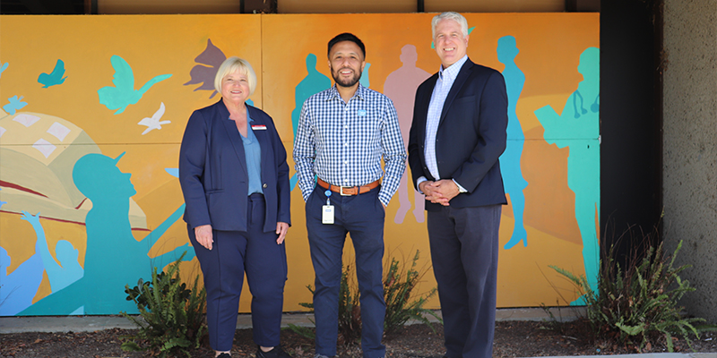 Foothill College, Star One Credit Union, and FHDA Foundation representatives stand in front of a campus mural.