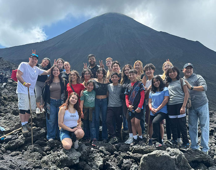 large standing on volanic rock with mountain in backgroud