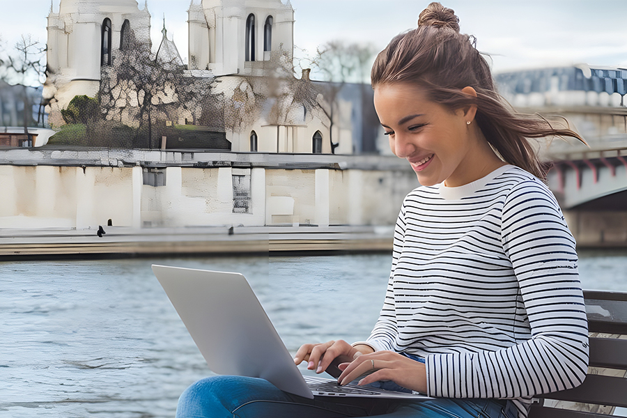 Female student in Paris taking class with a laptop