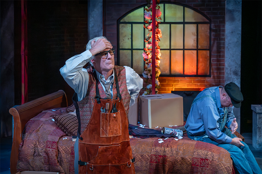 Actors performing a dramatic scene on a theater stage