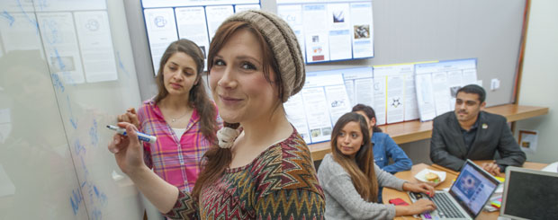 Female student at white board