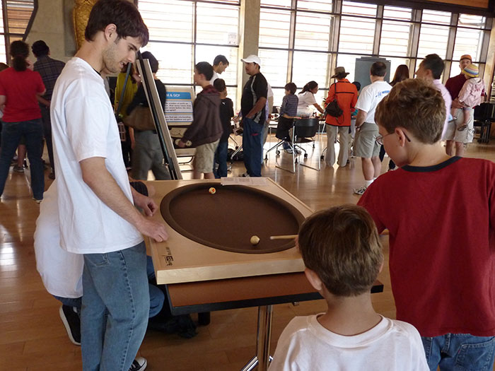 kids playing pool on an elliptical table