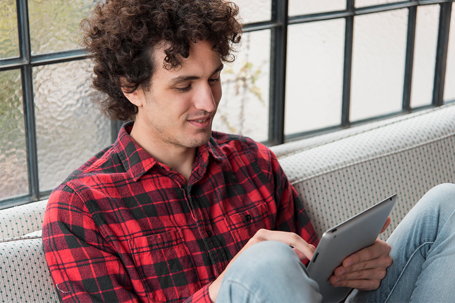 Male student searching on ipad about the eCHECKUP
