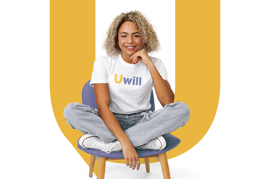 Uwill image - African American female seated on a chair with a big "U" Letter at the back