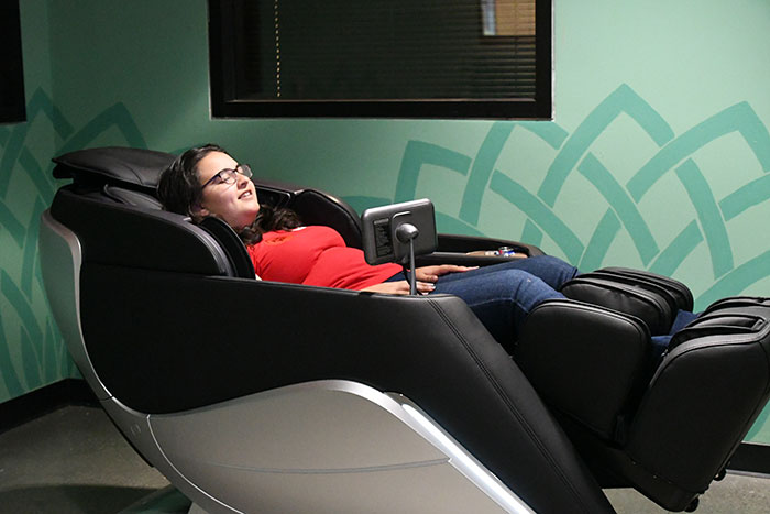 female student resting on massage chair