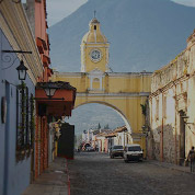 photo of street in guatemala with mountain in the background