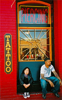 Jessica Chen's picture outside of a tattoo piercing shop