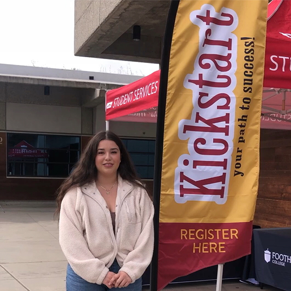 Student female next to a Kickstart signage