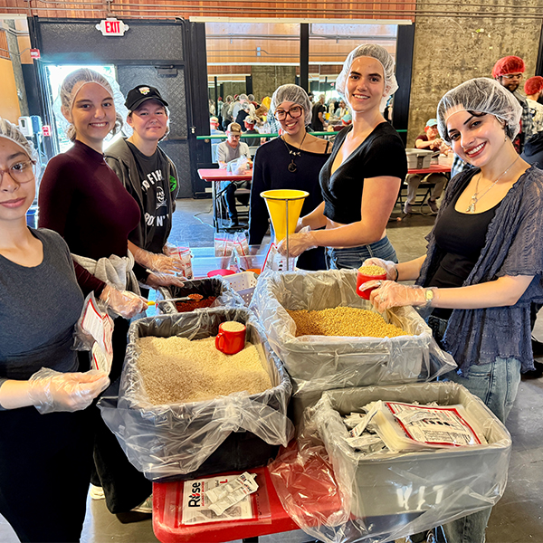 Volunteers packing food in boxes