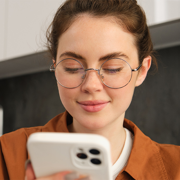 Student searching in her phone for a class at Foothill College