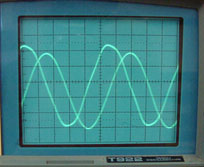 photo of oscilloscope output showing two out-of-phase sinusoids