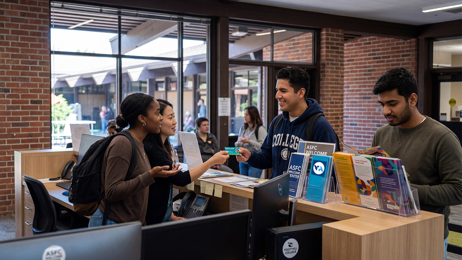 Students interacting at a campus welcome center desk