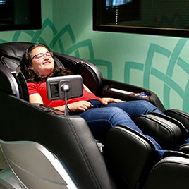 Wellness massage chair with smiling student relaxing